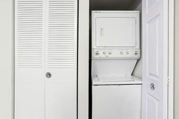 A white oven and microwave are installed in a kitchen.